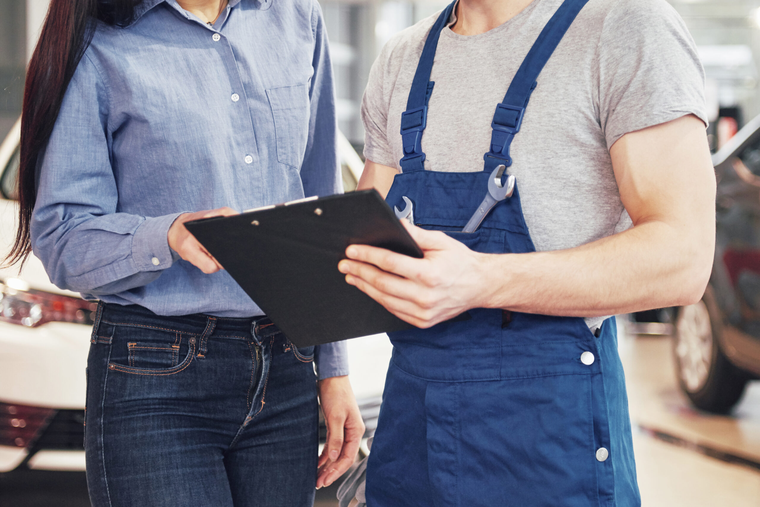 woman customer discussing car bumper repairs done her vehicle